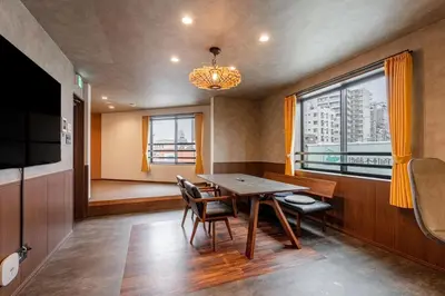 a dining room with a table and chairs and a window at SEEK Tokyo in Wada