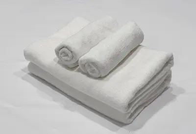 two rolled towels sitting on top of a table at SEEK Tokyo in Wada