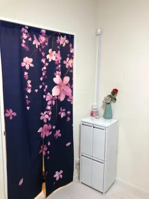 a room with a blue curtain with pink flowers at \u685c\u5c4bSakuraya201 in Tokyo