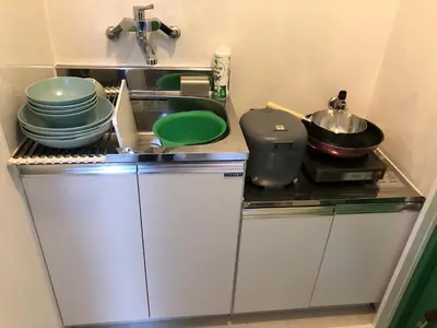 a kitchen with a sink and some dishes on a counter at \u685c\u5c4bSakuraya201 in Tokyo
