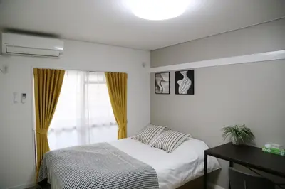 a bedroom with a bed and a window at Pr43 \u4e0b\u843d\u5408 in Tokyo