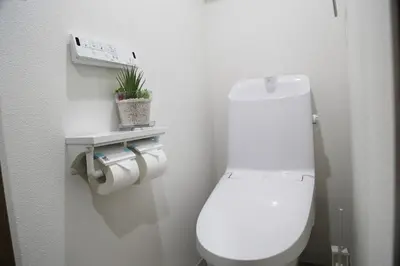 a white toilet in a bathroom with a plant at Pr43 \u4e0b\u843d\u5408 in Tokyo