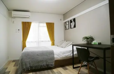 a bedroom with a bed and a desk and a window at Pr43 \u4e0b\u843d\u5408 in Tokyo