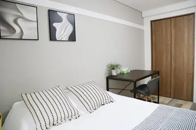 a bedroom with a white bed and a desk at Pr43 \u4e0b\u843d\u5408 in Tokyo