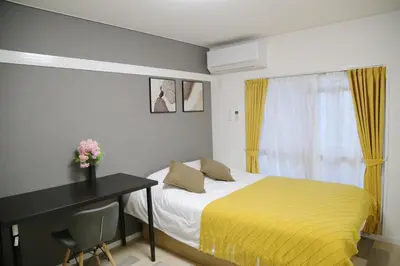 a bedroom with a bed and a desk and a window at Pr44\u4e0b\u843d\u5408 in Tokyo