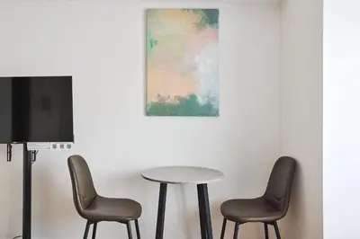 a table and two chairs and a tv in a room at \u30b3\u30b9\u30e2\u30ea\u30fc\u30c9\u5e61\u30f6\u8c37 in Tokyo