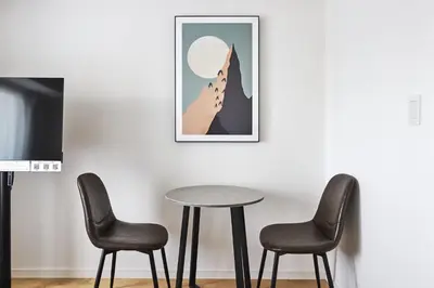 a table and two chairs in a room with a picture at \u30b3\u30b9\u30e2\u30ea\u30fc\u30c9\u5e61\u30f6\u8c37 in Tokyo