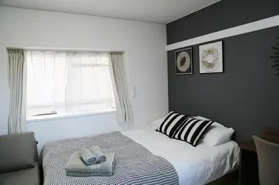 a bedroom with a bed with two towels on it at Pr46 \u4e0b\u843d\u5408 in Tokyo