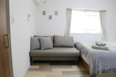 a small bedroom with a bed and a window at Pr46 \u4e0b\u843d\u5408 in Tokyo