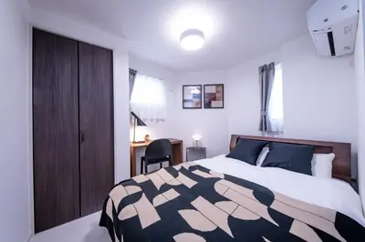 a bedroom with a bed and a desk in it at Hotel Comfortia in Tokyo