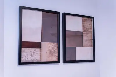 two framed mirrors on a white wall at Hotel Comfortia in Tokyo