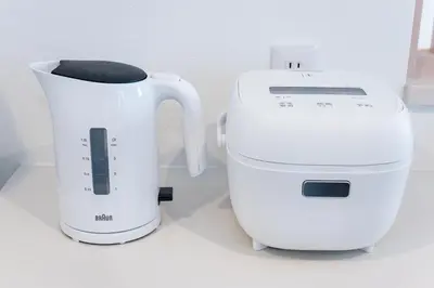 a white mixer next to a coffee maker at Hotel Comfortia in Tokyo