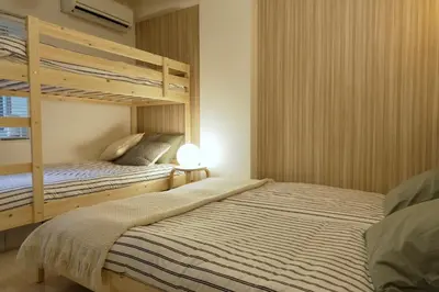 a bedroom with two bunk beds and a lamp at Tokyo Flash Hideout in Tokyo