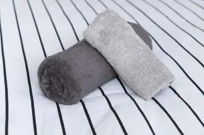 a pair of towels on top of a bed at Tokyo Flash Hideout in Tokyo