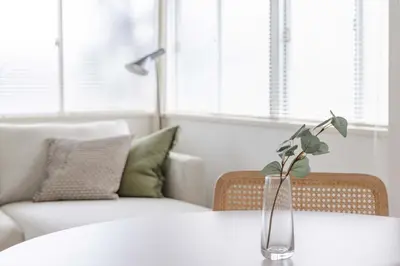 a vase with a plant on a table in a living room at Tokyo Flash Hideout in Tokyo