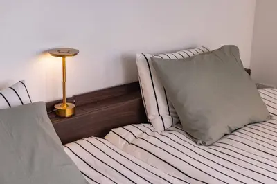 a bed with a pillow and a lamp in a room at Tokyo Flash Hideout in Tokyo