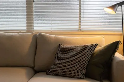 a couch with two pillows on it in a living room at Tokyo Flash Hideout in Tokyo