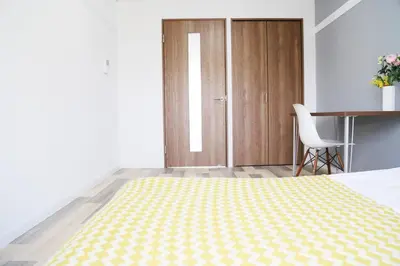a bedroom with a bed and a table and a chair at Pr52\u4e0b\u843d\u5408 in Tokyo