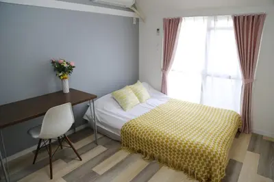 a bedroom with a bed and a desk and a window at Pr52\u4e0b\u843d\u5408 in Tokyo