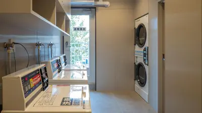 a laundry room with a washer and dryer at Toyoko Inn Tokyo Minowa-eki in Tokyo