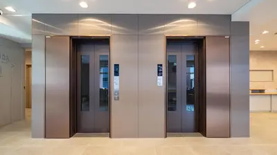 a row of elevator doors in a building at Toyoko Inn Tokyo Minowa-eki in Tokyo