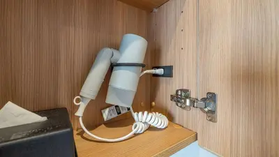 a microscope hanging on a wall in a room at Toyoko Inn Tokyo Minowa-eki in Tokyo