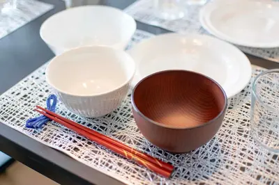 two cups and chopsticks on a table with plates and bowls at BAi\u304a\u82b1\u8336\u5c4b1\u4e01\u76ee\u30d1\u30fc\u30eb\u30cf\u30a4\u30c4201 in Tokyo