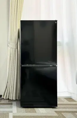 a black refrigerator in a room with curtains at ginza401 in Tokyo
