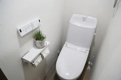 a white toilet in a bathroom with a plant at Pr53\u4e0b\u843d\u5408 in Tokyo