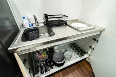 a kitchen counter with a sink next to a counter at \u30a2\u30f3\u30c9\u30b9\u30c6\u30a4\u5927\u5cf63\u4e01\u76ee in Tokyo