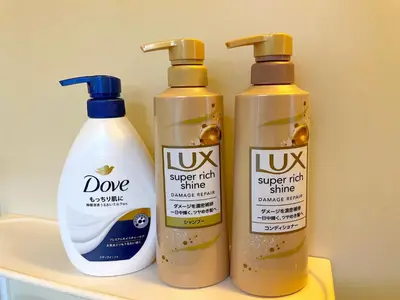 three bottles of cleaning products sitting on a shelf at Gest house Near Disneyland in Edogawa