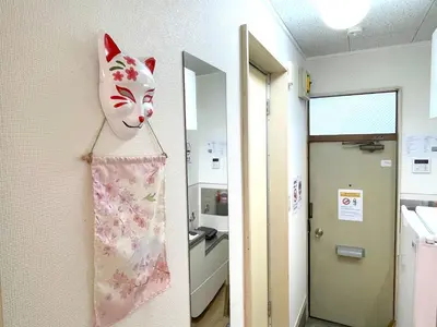a mask hanging on a wall in a hospital room at Gest house Near Disneyland in Edogawa