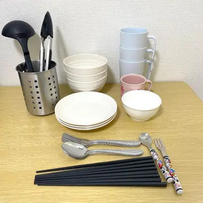 a table with plates and utensils on it at Gest house Near Disneyland in Edogawa