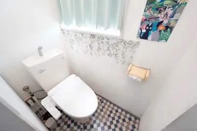 a small bathroom with a white toilet and a window at 100sqm,Shinjuku 5min, Shibuya 12min,4F No Elevetor in Tokyo
