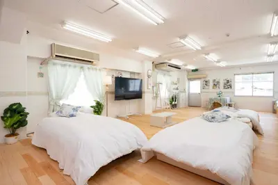 a bedroom with two beds and a flat screen tv at 100sqm,Shinjuku 5min, Shibuya 12min,4F No Elevetor in Tokyo