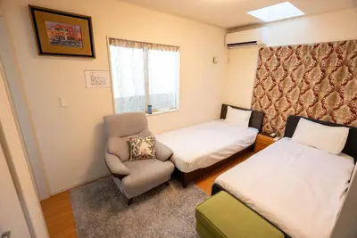a small room with a bed and a chair at shinjuku premier suites tokyo in Tokyo