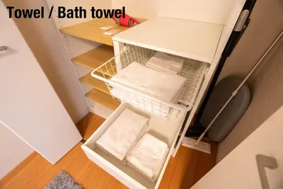 a small refrigerator with its door open with towels at shinjuku premier suites tokyo in Tokyo