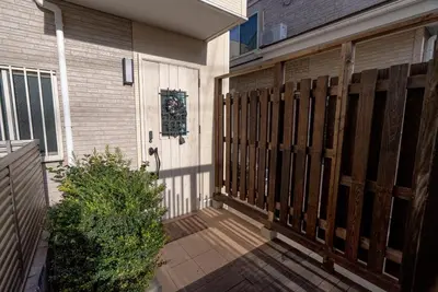 a front door of a house with a wooden fence at shinjuku premier suites tokyo in Tokyo