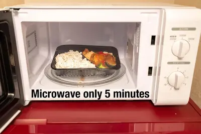 a microwave oven with a pan of food in it at shinjuku premier suites tokyo in Tokyo