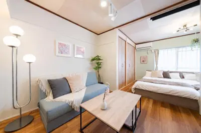 a living room with a couch and a bed at Sakura Inn Tokyo Skytree in Tokyo
