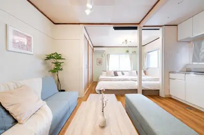 a living room with a couch and a bed at Sakura Inn Tokyo Skytree in Tokyo
