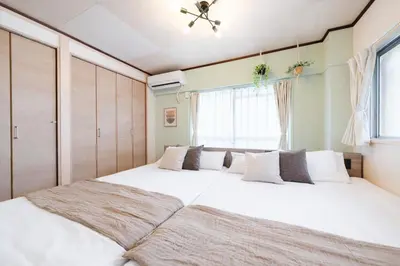 a bedroom with a large white bed with a window at Sakura Inn Tokyo Skytree in Tokyo
