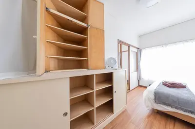 a bedroom with a book shelf and a bed at The North Ikebukuro Hotel in Tokyo
