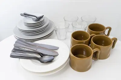 a table with plates and cups and utensils at The North Ikebukuro Hotel in Tokyo