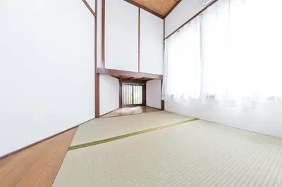 an empty room with white walls and a large window at The North Ikebukuro Hotel in Tokyo