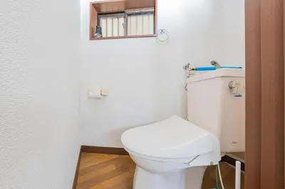 a bathroom with a white toilet and a mirror at The North Ikebukuro Hotel in Tokyo