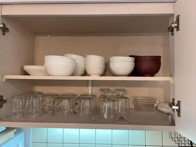 a cupboard filled with glass jars and bowls at BAi\u304a\u82b1\u8336\u5c4b1\u4e01\u76ee\u30d1\u30fc\u30eb\u30cf\u30a4\u30c4202 in Tokyo