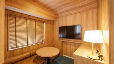 a small room with a table and a television at HOTEL AMANEK Asakusa Sakurabashi in Tokyo