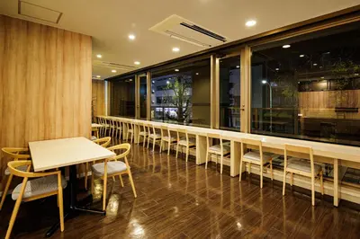 a row of tables and chairs in a restaurant at HOTEL AMANEK Asakusa Sakurabashi in Tokyo