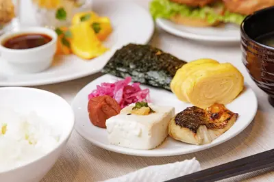 a plate of food on a table with rice and sushi at HOTEL AMANEK Asakusa Sakurabashi in Tokyo